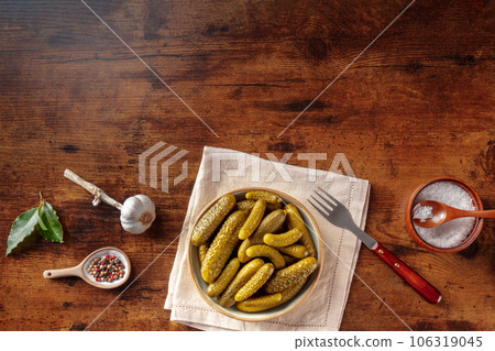 Pickled cucumbers with salt, pepper, garlic, and bay leaf 106319045