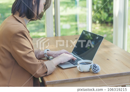 Close up Woman Hands love drinking hot coffee working from home. Business women with black coffee or hot chocolate cafe. Businesswoman hand typing laptop drink black coffee cup in green garden cafe Close up Woman Hands love drinking hot coffee working from home. Business women with black coffee or hot chocolate cafe. Businesswoman hand typing laptop drink black coffee cup in green garden cafe 106319215