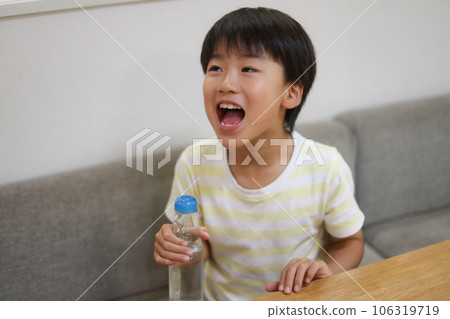 A boy drinking a ramney A boy drinking a ramney 106319719