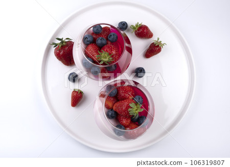 Fruit jelly dessert or panna cotta with fresh strawberries and blueberries, banner, copy space, menu, on white background. 106319807