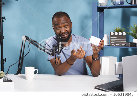 Online streamer broadcasting photography professional lightning equipment and looking at camera. Social media man blogger recommending videography tool while recording video 106319843