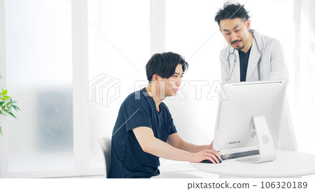 Medical staff talking while looking at a computer doctor nurse 106320189