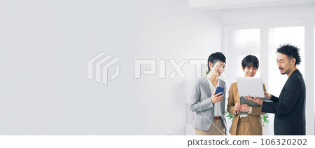 A group of business people talking while looking at a computer 106320202
