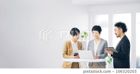 A group of business people talking while looking at a computer 106320203