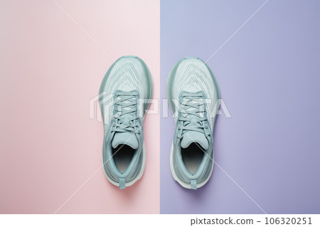 New light blue green female modern running shoe on pink purple geometrical background. Stylish monochrome shoes for active people that incorporate new health technology. Top view 106320251