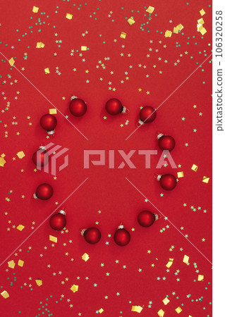 Christmas composition. Christmas round frame made of toys on red background. Little shining stars. Flat Lay, Copy Space. Christmas composition. Christmas round frame made of toys on red background. Little shining stars. Flat Lay, Copy Space. 106320258