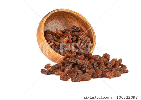 Sweet dehydrated raisins in a bowl and on a white background. Sweet dehydrated raisins in a bowl and on a white background. 106322098