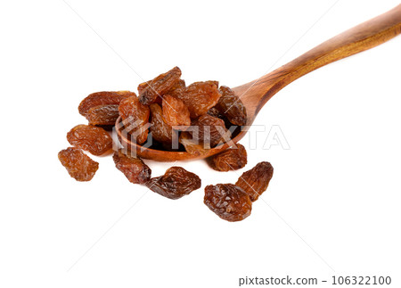 Wooden spoon with raisins on a white background. 106322100