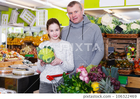 Portrait of man customer with daughter during shopping 106322469