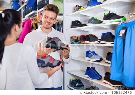 Young couple choosing new sneakers in sports store 106322476