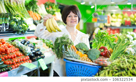 Mature woman buying fresh fruits and vegetables Mature woman buying fresh fruits and vegetables 106322534