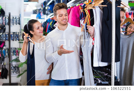 Couple choosing new sportswear in sports store 106322551