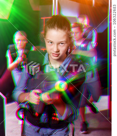 Teen girl with laser pistol on dark labyrinth 106322683