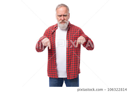 60 year old gray-haired pensioner man with a beard and mustache shows his finger to the side 60 year old gray-haired pensioner man with a beard and mustache shows his finger to the side 106322814