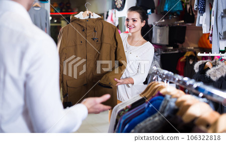 loving couple deciding on warm suit in sports store loving couple deciding on warm suit in sports store 106322818