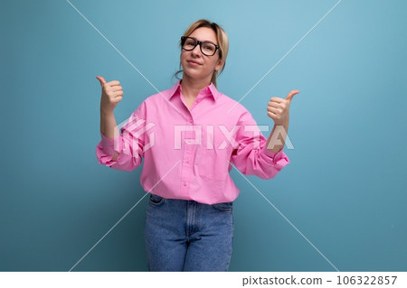 european young blond businesswoman in a pink shirt and jeans is actively gesturing on a studio 106322857