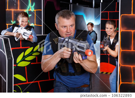 Man with laser pistol playing laser tag 106322893