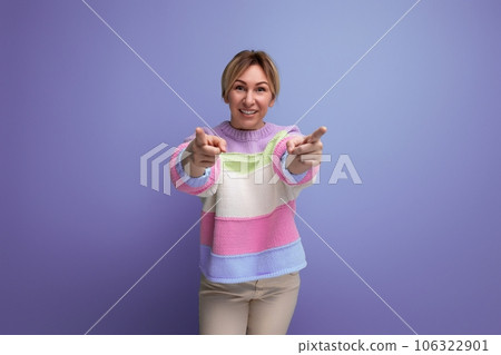 charming blond young woman showing class ahead on purple background with copy space 106322901