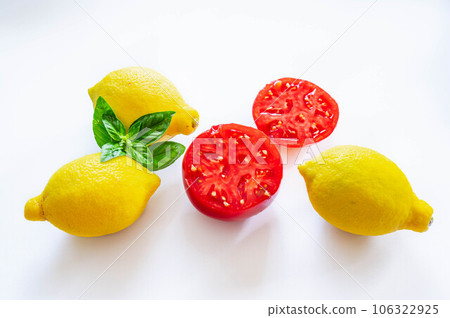 Ripe tomatoes and lemons cut in half 106322925