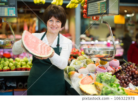 Mature woman offering watermelon Mature woman offering watermelon 106322978