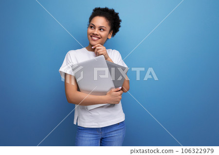 young smart hispanic business woman in white t-shirt got working remotely with laptop. business young smart hispanic business woman in white t-shirt got working remotely with laptop. business 106322979