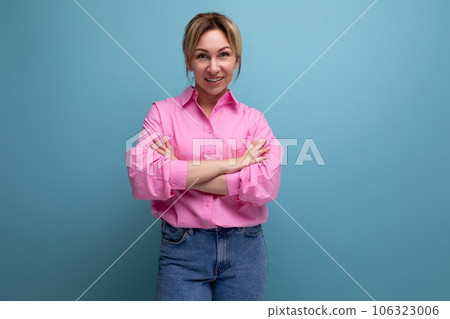 young positive pleasant european blond leader woman with ponytail dressed in pink blouse on studio 106323006