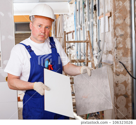 Worker picking ceramic tiles Worker picking ceramic tiles 106323026