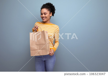 afro brunette latin young woman holding craft bag with printable mockup afro brunette latin young woman holding craft bag with printable mockup 106323047