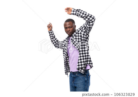 positive young american man in casual shirt dancing on white background with copy space 106323829