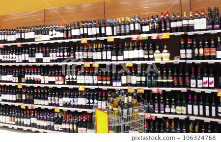 Many red and white wines lined up on Italian supermarket shelves Many red and white wines lined up on Italian supermarket shelves 106324768