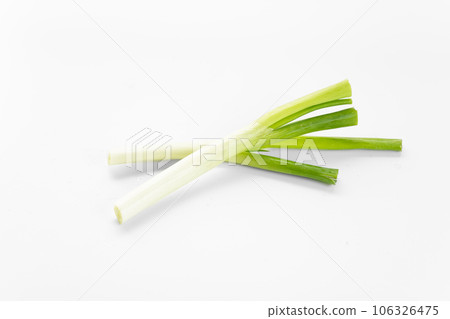 Scallions on a white background board. Scallions on a white background board. 106326475
