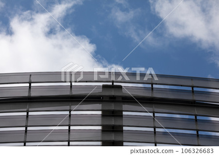 A modern sports hall with a panel facade that mimics louvers. 106326683