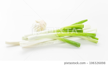 Scallions, chili peppers, and garlic on a white background board Scallions, chili peppers, and garlic on a white background board 106326898