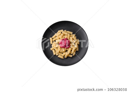 Delicious fusilli pasta with beetroot pesto, parmesan, salt and spices Delicious fusilli pasta with beetroot pesto, parmesan, salt and spices 106328038