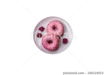 Delicious fresh sweet donuts in pink glaze with strawberry filling Delicious fresh sweet donuts in pink glaze with strawberry filling 106328053