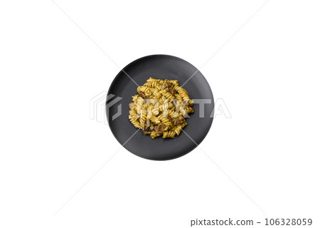 Delicious fusilli pasta with green pesto sauce, with salt and spices Delicious fusilli pasta with green pesto sauce, with salt and spices 106328059