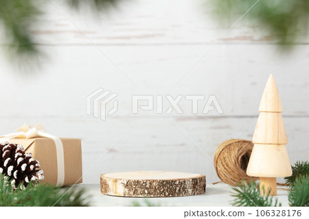 Wooden podium with branches of Christmas tree, gift and cone on vintage wood background. Concept scene stage showcase, product, promotion sale, presentation, beauty cosmetic. 106328176