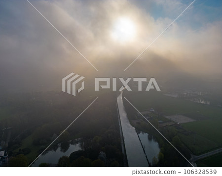 Mystical Morning: Aerial Panoramic View of River, Farm Field, and Forest Landscape in Morning Fog Mystical Morning: Aerial Panoramic View of River, Farm Field, and Forest Landscape in Morning Fog 106328539