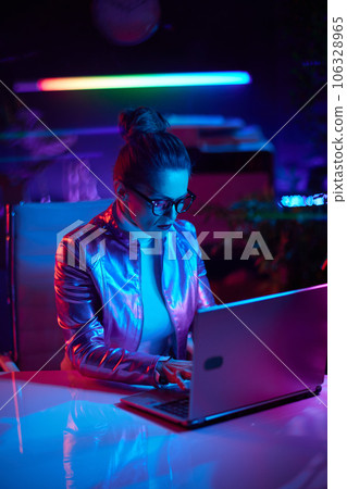 modern woman in glasses using laptop in modern office modern woman in glasses using laptop in modern office 106328965
