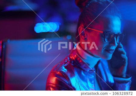 elegant 40 years old woman in glasses talking on smartphone 106328972