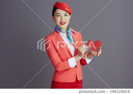 happy stylish air hostess asian woman isolated on grey 106329028
