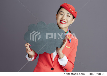 asian female flight attendant showing blank cloud shape board asian female flight attendant showing blank cloud shape board 106329038