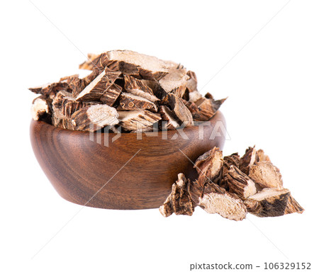 Calamus root in wooden bowl, isolated on white background. Sweet flag, sway or muskrat root. Dry root of Acorus calamus. Calamus root in wooden bowl, isolated on white background. Sweet flag, sway or muskrat root. Dry root of Acorus calamus. 106329152