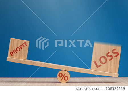 Increasing losses in the stock market. Loss and profit on the scales on a blue background. Loss of investment in stock exchange, bear market and recession concept. 106329319