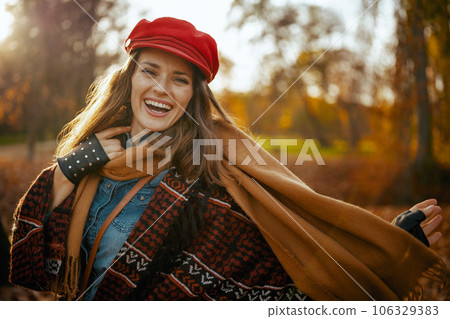 Portrait of happy elegant 40 years old woman in red hat 106329383