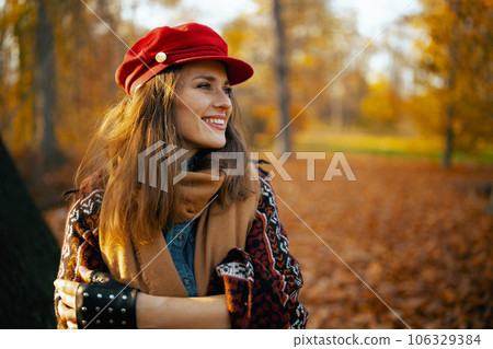 happy elegant female in red hat with scarf and gloves 106329384
