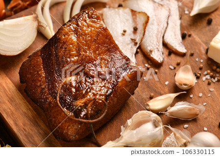 still life of food in a rural style on a dark wood background, sliced lard and garlic, cheese and onion, concept of fresh vegetables and healthy food still life of food in a rural style on a dark wood background, sliced lard and garlic, cheese and onion, concept of fresh vegetables and healthy food 106330115