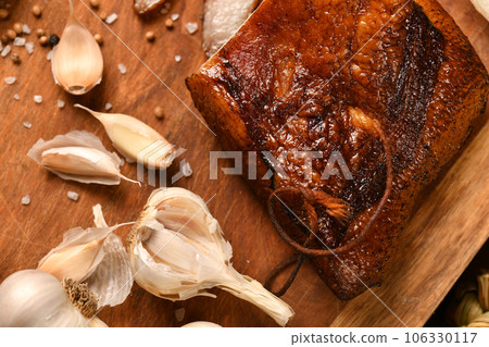 still life of food in a rural style on a dark wood background, sliced lard and garlic, salt and pepper, concept of fresh vegetables and healthy food 106330117