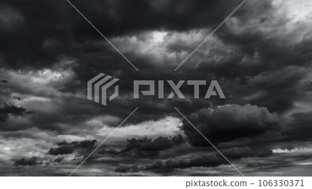 dark dramatic sky with black stormy clouds before rain or snow as abstract background, extreme weather, the sun shines through the clouds, high contrast photo dark dramatic sky with black stormy clouds before rain or snow as abstract background, extreme weather, the sun shines through the clouds, high contrast photo 106330371