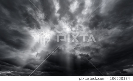 dark dramatic sky with black stormy clouds before rain or snow as abstract background, extreme weather, the sun shines through the clouds, high contrast photo dark dramatic sky with black stormy clouds before rain or snow as abstract background, extreme weather, the sun shines through the clouds, high contrast photo 106330384